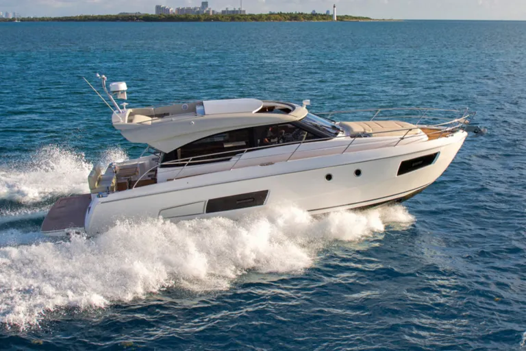 A flybridge motor yacht under way at speed
