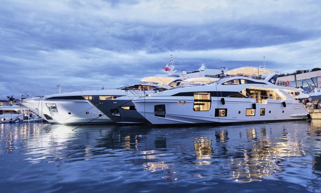 Motor yachts moored in a marina at dusk