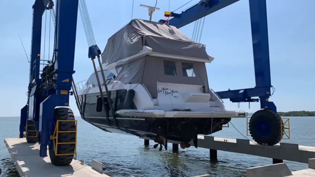 Motor yacht lifted out of the water by a travel lift