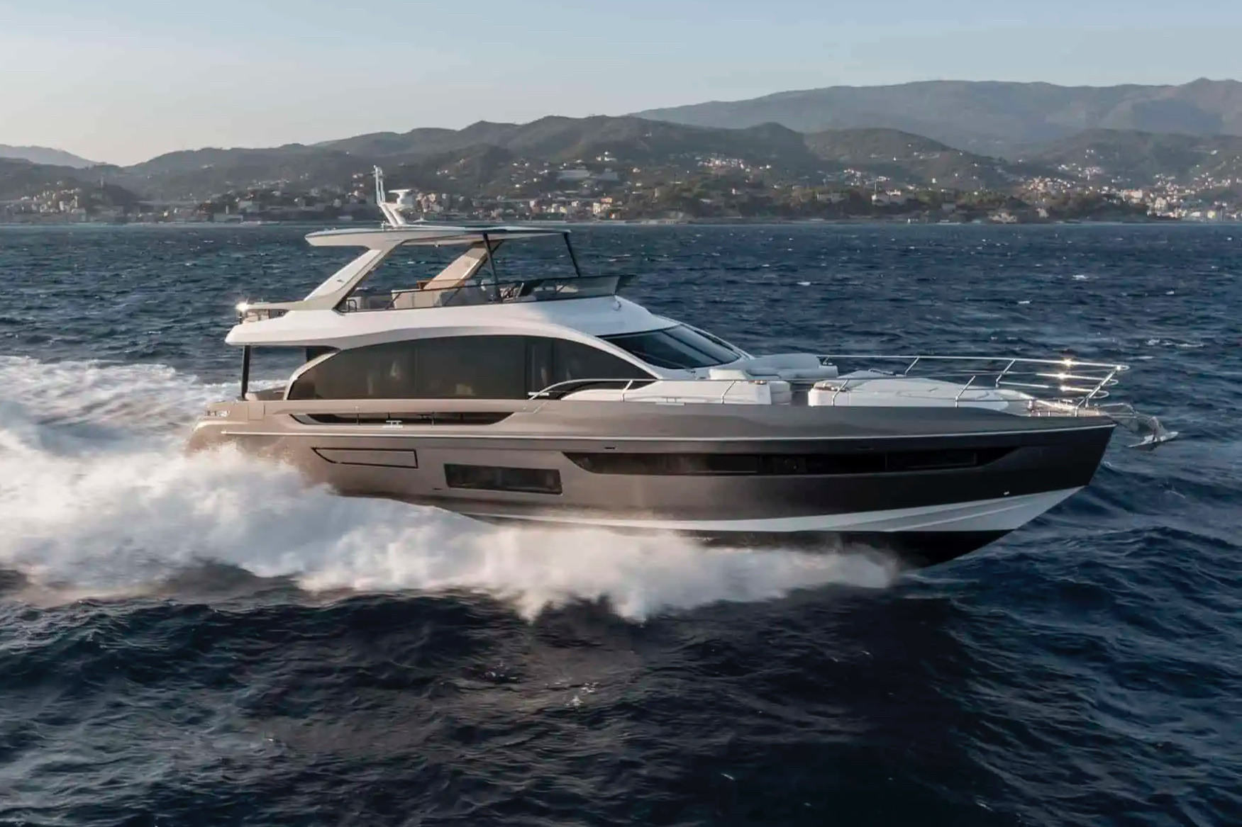 An Azimut flybridge motor yacht under way with a bronze hull