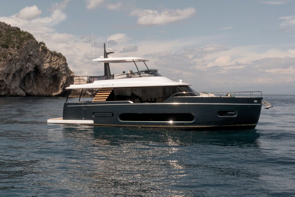 An Azimut Magellano with a dark hull at rest in calm water